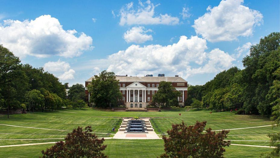 Large traditional building with columns - McKeldin Library. Fountain pools in front with student walking on pathways